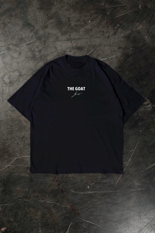 Black t-shirt with 'THE GOAT' text on a textured dark surface