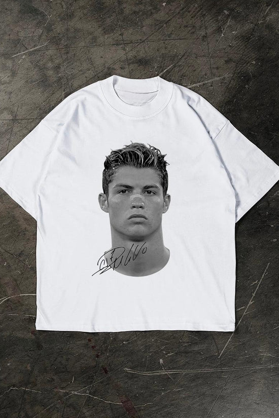 White t-shirt with a graphic of a Cristiano Ronaldo on a textured dark background