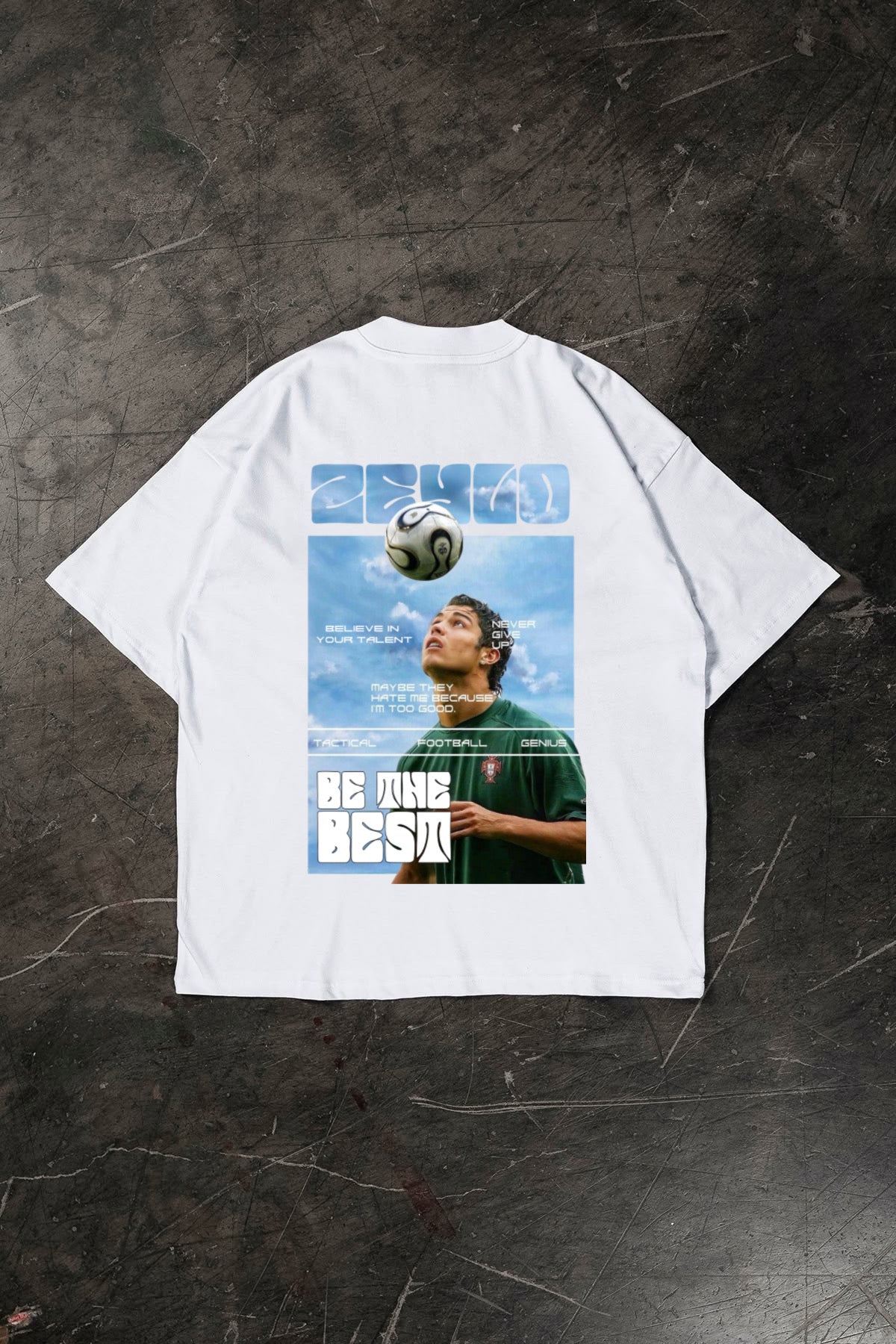 White t-shirt with a graphic of a Cristiano Ronaldo and text on a dark textured background