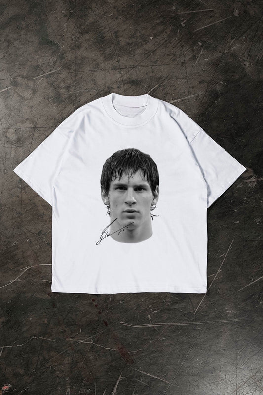White t-shirt with a black and white graphic of a Lionel Messi on a textured dark surface